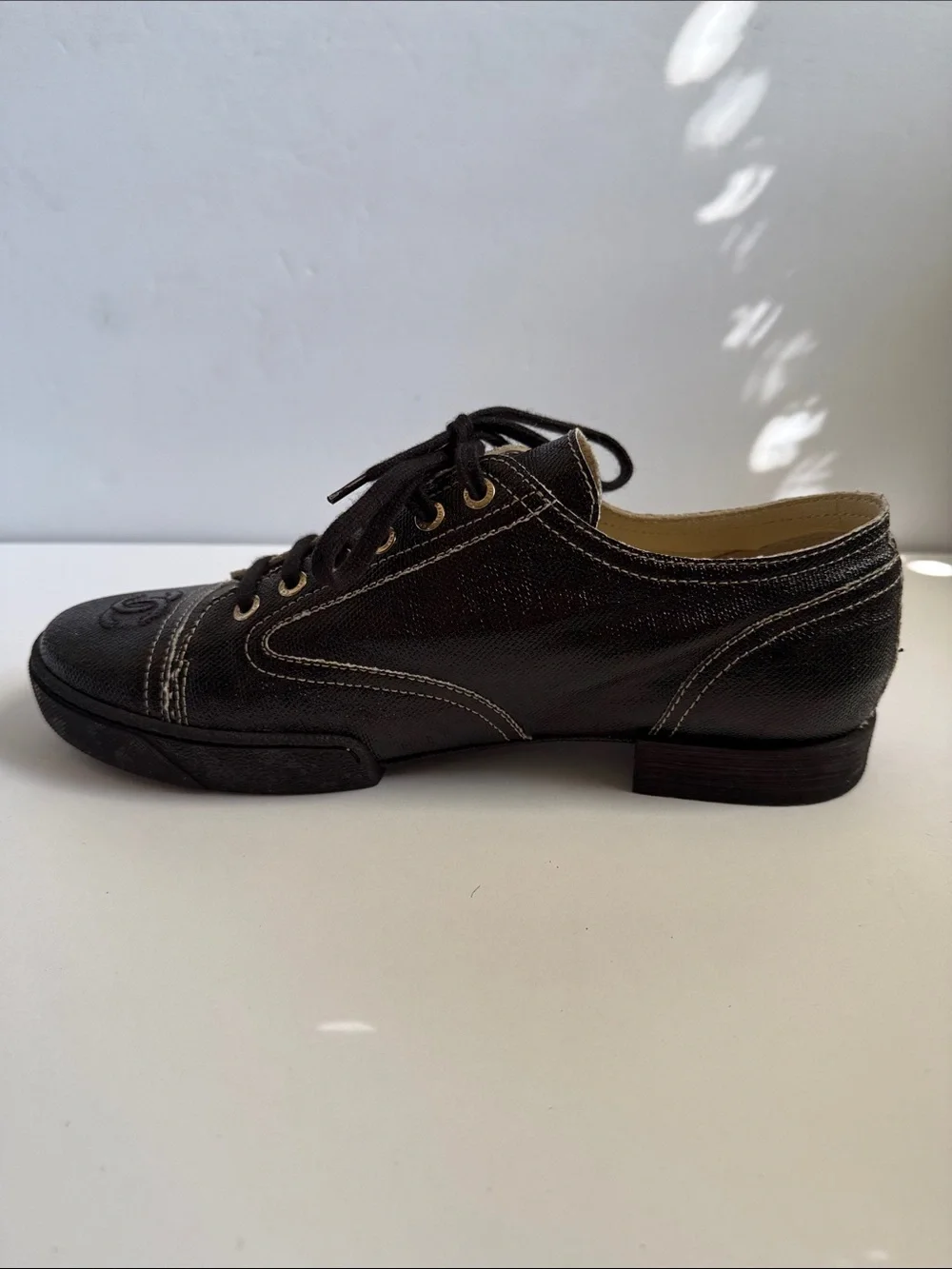 CHANEL Shiny Black Coated Canvas Lace-Up Sneakers with Gold Gromets